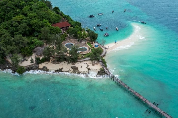 Aerial view of tropical coastline, resort, and turquoise water