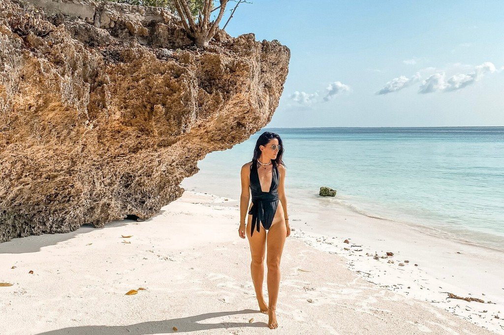 White sand beach with turquoise water and coastal rock formations
